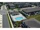Aerial view of community pool with lounge area surrounded by modern townhomes at 391 Cape Honeysuckle Pl, Sanford, FL 32771