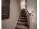 Carpeted staircase leading to the upper level with white railing at 391 Cape Honeysuckle Pl, Sanford, FL 32771