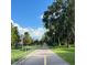 Scenic paved path with lush green trees and landscaping, perfect for walking, running, or biking at 391 Cape Honeysuckle Pl, Sanford, FL 32771
