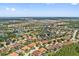High-angle aerial view of a vibrant neighborhood with many single-Gathering homes and some ponds at 4080 Oaktree Dr, Davenport, FL 33837