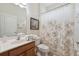 Clean bathroom with a vanity, toilet, and tub-shower combination featuring a floral-patterned shower curtain at 4080 Oaktree Dr, Davenport, FL 33837