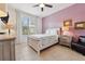 Cozy bedroom with a comfortable bed, a ceiling fan, and plenty of natural light at 4080 Oaktree Dr, Davenport, FL 33837