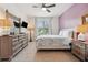 Bedroom with a ceiling fan, and dresser, offering a cozy and well-lit space at 4080 Oaktree Dr, Davenport, FL 33837