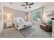 Bedroom featuring a well-lit window, neutral color scheme, and cozy seating at 4080 Oaktree Dr, Davenport, FL 33837