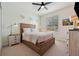 Cozy bedroom featuring a wooden bed frame, carpeted floor, and a large window for natural light at 4080 Oaktree Dr, Davenport, FL 33837