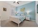 Charming bedroom with coastal-themed decor, including a white bed frame and blue accent wall at 4080 Oaktree Dr, Davenport, FL 33837