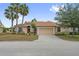 Inviting single-story house featuring a tile roof, two-car garage, and well-maintained front lawn at 4080 Oaktree Dr, Davenport, FL 33837