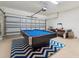 Spacious game room with pool table, air hockey, and garage access at 4080 Oaktree Dr, Davenport, FL 33837