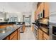 Kitchen with stainless steel appliances, tile backsplash, granite countertops, and breakfast nook at 4080 Oaktree Dr, Davenport, FL 33837