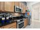 Modern kitchen with stainless steel appliances, a tile backsplash, and wood cabinets at 4080 Oaktree Dr, Davenport, FL 33837
