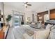 Bright living room with tile flooring, ceiling fan, and sliding glass doors to the outdoor area at 4080 Oaktree Dr, Davenport, FL 33837