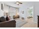 Inviting living room featuring comfortable seating, a stylish rug, and view to a serene bedroom beyond at 4080 Oaktree Dr, Davenport, FL 33837