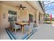 Outdoor dining area on covered patio with ceiling fan and backyard views at 4080 Oaktree Dr, Davenport, FL 33837
