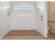 Walk-in shower with tile surround, bench, and handrails at 4080 Oaktree Dr, Davenport, FL 33837