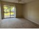 Spacious bedroom with sliding glass doors and neutral carpet at 4596 Pheasant Run Dr # C, Orlando, FL 32808