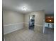 Dining area featuring tile flooring, neutral walls, and a pass-through view to the kitchen at 4596 Pheasant Run Dr # C, Orlando, FL 32808