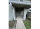 Inviting condo entrance featuring a concrete walkway, neutral-colored exterior, and visible unit number at 4596 Pheasant Run Dr # C, Orlando, FL 32808