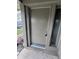 A close-up of a solid front door with a sidelight, set in a neutral-colored exterior at 4596 Pheasant Run Dr # C, Orlando, FL 32808