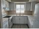 Bright kitchen features stainless steel sink, modern faucet, white cabinets and countertops at 4596 Pheasant Run Dr # C, Orlando, FL 32808