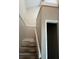A carpeted stairwell leading upstairs with white railings and neutral-colored walls at 4596 Pheasant Run Dr # C, Orlando, FL 32808