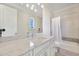 Well-lit bathroom featuring a marble countertop, shower and a tub at 521 S Phelps Ave, Winter Park, FL 32789