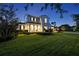 Charming home at dusk with meticulously maintained landscaping and inviting curb appeal at 521 S Phelps Ave, Winter Park, FL 32789