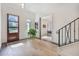 Inviting foyer with hardwood floors, a staircase, and views into an adjacent office space at 521 S Phelps Ave, Winter Park, FL 32789