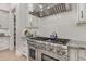 Gourmet kitchen featuring a professional grade range, custom cabinets, and stone countertops at 521 S Phelps Ave, Winter Park, FL 32789