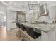 Modern kitchen featuring a large island with seating, stainless steel appliances, and stylish pendant lighting at 521 S Phelps Ave, Winter Park, FL 32789