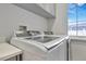 Well-equipped laundry room with modern washer and dryer units and ample storage at 521 S Phelps Ave, Winter Park, FL 32789