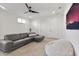 Cozy living room featuring a gray sectional sofa, a ceiling fan, and neutral-toned carpeting at 521 S Phelps Ave, Winter Park, FL 32789