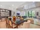 Open concept living and dining area with hardwood floors, large windows, and a stylish wet bar at 521 S Phelps Ave, Winter Park, FL 32789