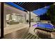 Outdoor patio and pool area featuring a pergola, outdoor kitchen, lounge chairs, and sliding glass doors into the home at 521 S Phelps Ave, Winter Park, FL 32789