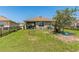 Spacious backyard with a trampoline, playhouse, and black metal fence, perfect for outdoor activities at 5234 Bear Corn Run, Port Orange, FL 32128