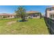 Spacious backyard with playhouse and black metal fence, perfect for outdoor activities at 5234 Bear Corn Run, Port Orange, FL 32128