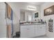 Well-lit bathroom featuring double sinks, a large mirror, and a clean, modern shower with glass door at 5234 Bear Corn Run, Port Orange, FL 32128