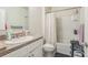 A clean bathroom with a shower and tub combo and a vanity with marble countertops at 5234 Bear Corn Run, Port Orange, FL 32128