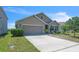 Charming single-story home with a well-maintained lawn, two car garage and a neatly landscaped garden at 5234 Bear Corn Run, Port Orange, FL 32128