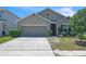 Charming single-story home with a well-maintained lawn, two car garage and a neatly landscaped garden at 5234 Bear Corn Run, Port Orange, FL 32128