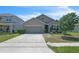 Charming single-story home with a well-maintained lawn, two car garage and a neatly landscaped garden at 5234 Bear Corn Run, Port Orange, FL 32128