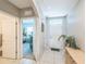 Inviting hallway with tile flooring, a view into a bedroom, and a decorative plant near the front door at 5234 Bear Corn Run, Port Orange, FL 32128