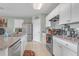 Spacious kitchen with stainless steel appliances, ample counter space, and white cabinetry at 5234 Bear Corn Run, Port Orange, FL 32128
