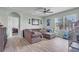Inviting living room features wood flooring and a large window offering natural light, plus comfortable seating at 5234 Bear Corn Run, Port Orange, FL 32128