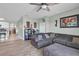 Cozy living room featuring a comfortable sectional sofa, ceiling fan, and tile floors, creating a relaxing ambiance at 5234 Bear Corn Run, Port Orange, FL 32128