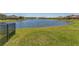 Scenic view of the pond, surrounded by lush green grass and neighboring houses in the community at 5234 Bear Corn Run, Port Orange, FL 32128