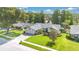 Aerial view of a beautifully landscaped home featuring a well-manicured lawn and inviting curb appeal at 623 Tuskawilla Point Ln, Winter Springs, FL 32708