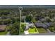 Stunning aerial view of a landscaped property with lush greenery and a tranquil pond at 623 Tuskawilla Point Ln, Winter Springs, FL 32708