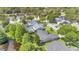 Aerial view showcasing the neighborhood, featuring a swimming pool, and lush green trees at 623 Tuskawilla Point Ln, Winter Springs, FL 32708