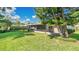 The backyard features a screened-in patio, manicured hedges, and a lush lawn at 623 Tuskawilla Point Ln, Winter Springs, FL 32708