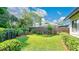 Well-maintained backyard featuring a lush green lawn and beautiful landscaping, perfect for outdoor activities and relaxation at 623 Tuskawilla Point Ln, Winter Springs, FL 32708